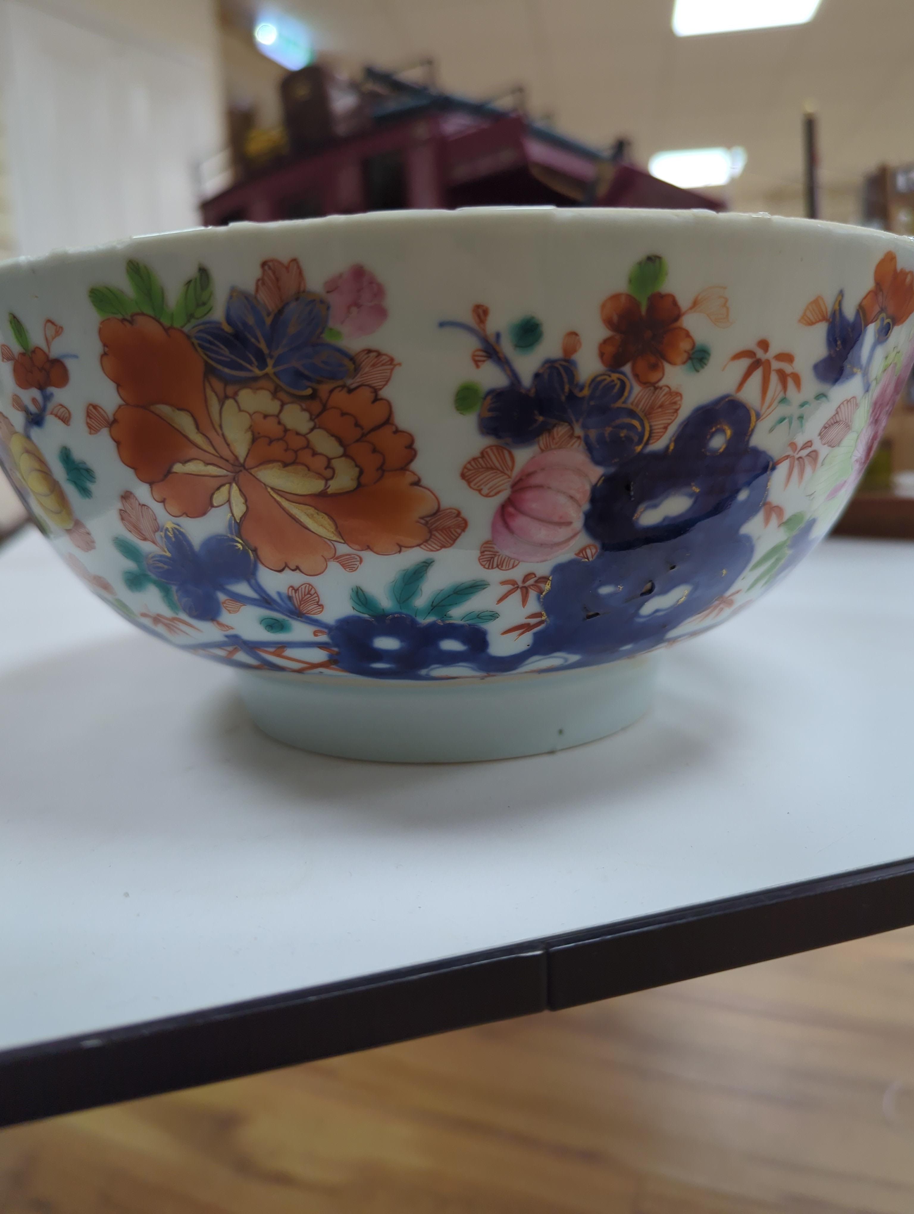 An 18th century Chinese famille rose bowl and a group of five Chinese wucai plates, each decorated with fruit, the bowl 23cm in diameter